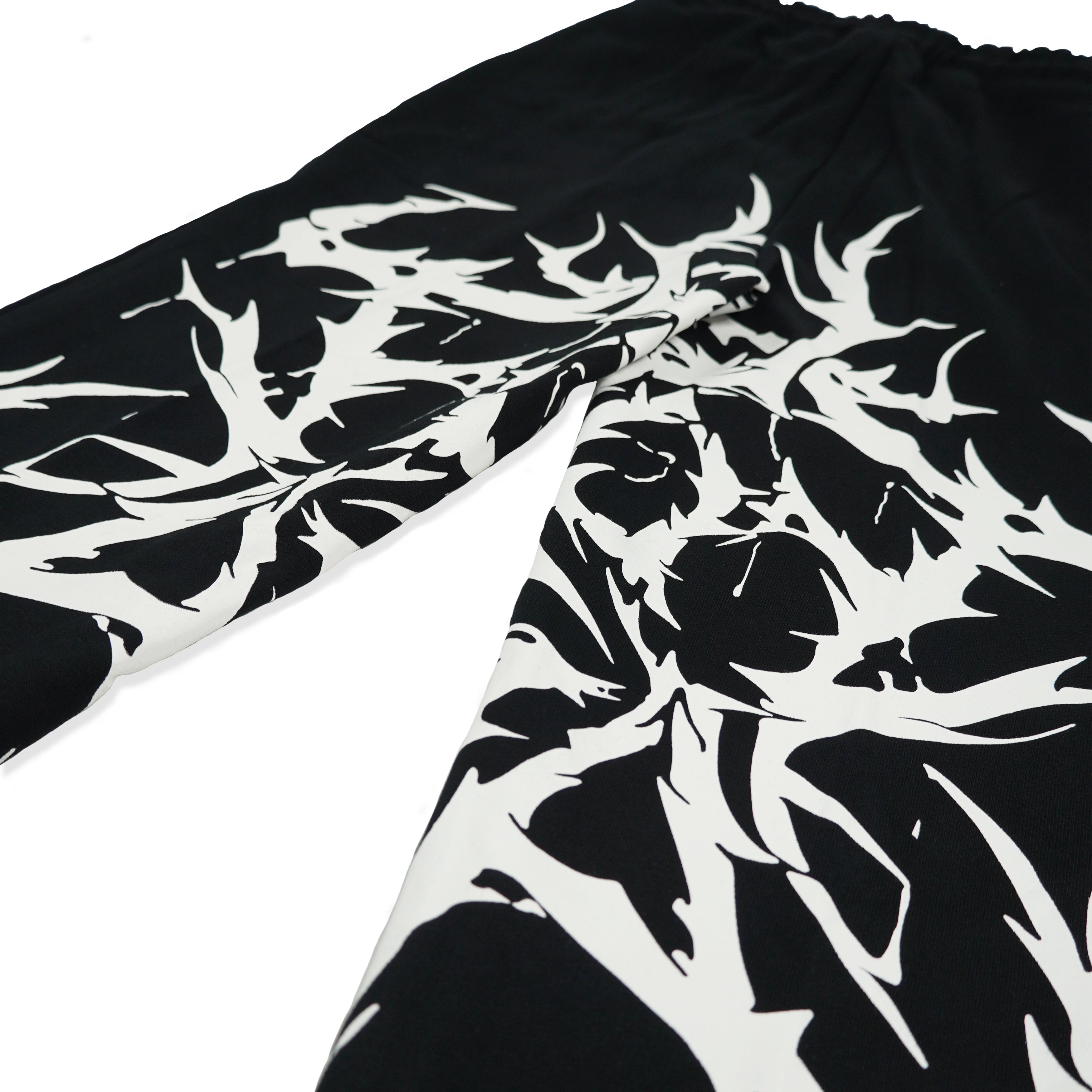 Close-up of FA Black Metal Joggers with white abstract design, featuring a sleek tapered ankle, made from 80% cotton and 20% polyester.